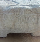 The unique stone relief based on the actual seven-branched candelabra that stood in the Jerusalem Temple. This representation was made before the destruction of the original candelabra in the year 70 C.E.